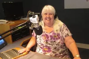 Woman presenting in radio studio.