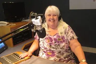 Woman presenting in radio studio.